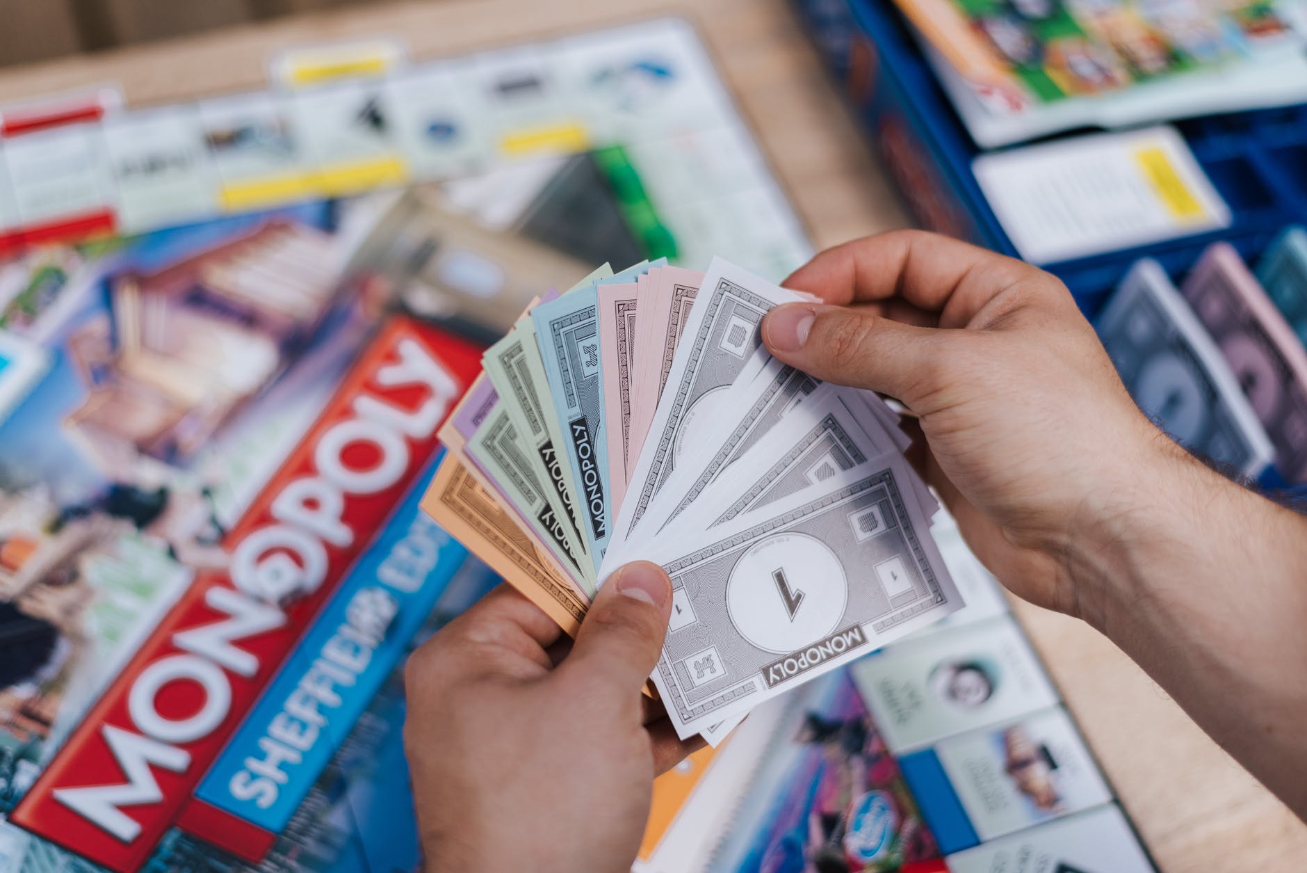 faceless player with fake banknotes playing table game