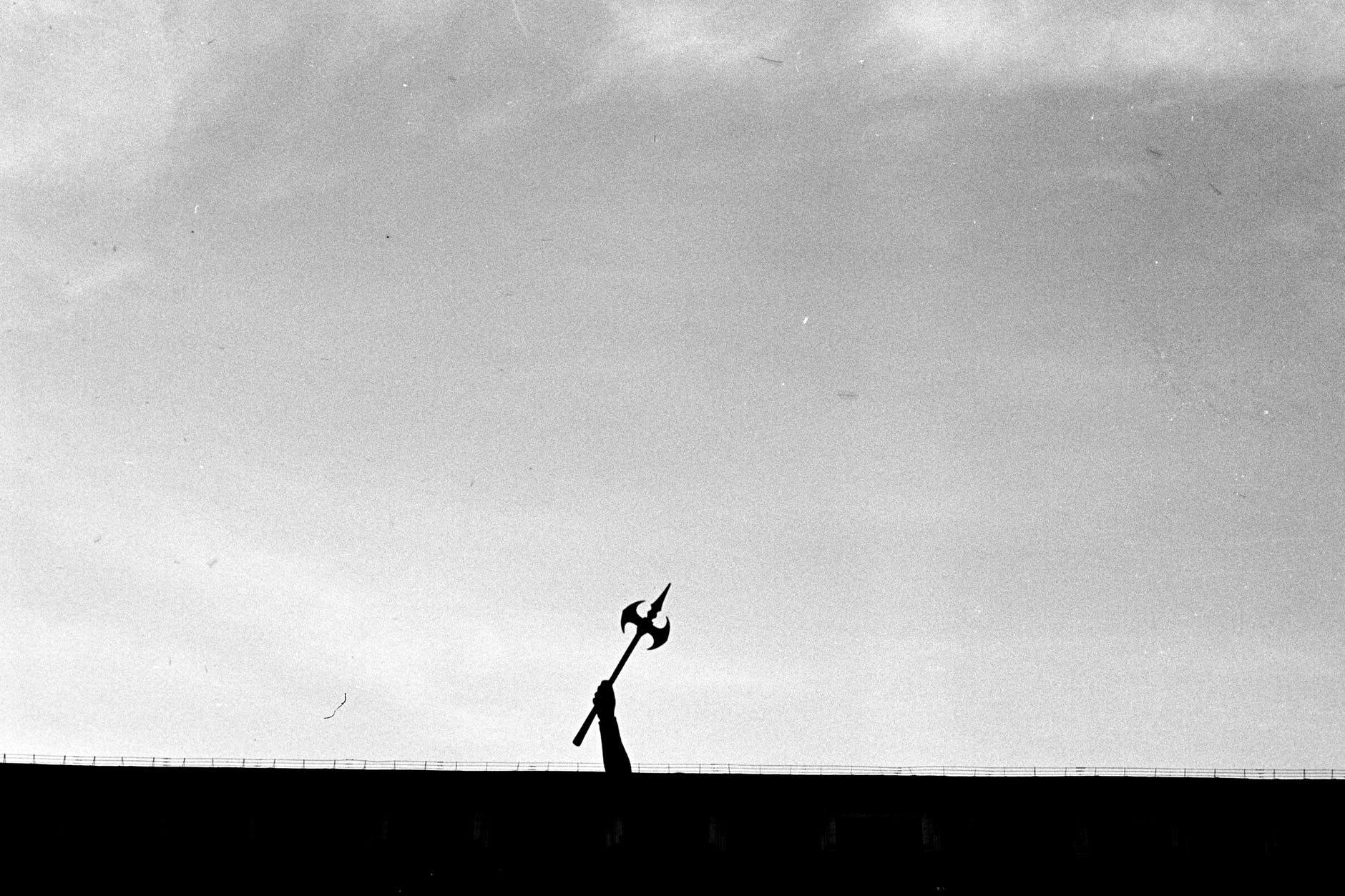 silhouette of man jumping on the field